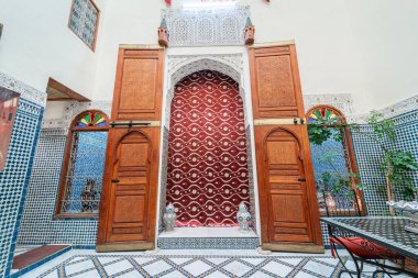 Büyük ahşap kapı Fas 'ta geleneksel Riad' ın içindeki bir Fas salonuna açıldı.