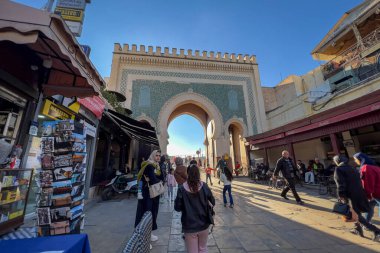 People walking nearby Bab Boujloud in the old Medina of Fes, Morocco