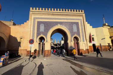 People walking nearby Bab Boujloud in the old Medina of Fes, Morocco