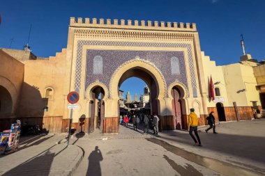 People walking nearby Bab Boujloud in the old Medina of Fes, Morocco