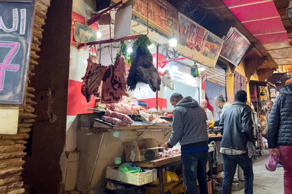 People walking through the food marketplace in the old down of Fes, Morocco