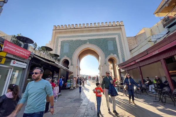 People walking nearby Bab Boujloud in the old Medina of Fes, Morocco