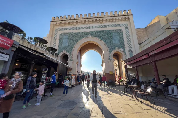 People walking nearby Bab Boujloud in the old Medina of Fes, Morocco