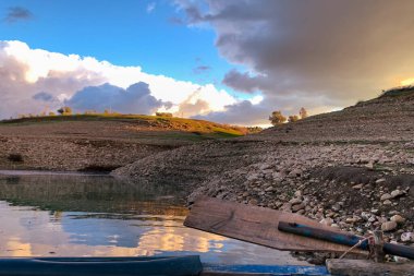 Silhouette reflection of the sunset on a large dam
