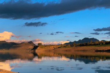 Silhouette reflection of the sunset on a large dam