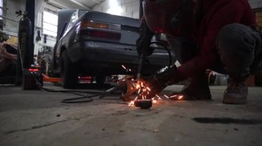 Kaynakçı, özel arabalar için metal yapıların kaynak işlerini yapıyor.