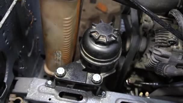 整備士は修理とチューニングのため赤いリフトに古い汚い車のエンジンを分解します — ストック動画