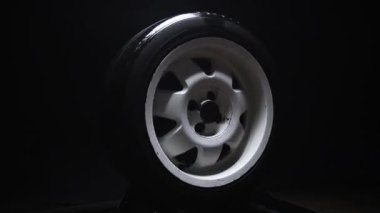 spinning car wheels white shooting video on long exposure motion effect