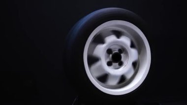 spinning car wheels white shooting video on long exposure motion effect