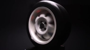 old car wheels titanium rims long exposure video on dark background spinning motion simulation