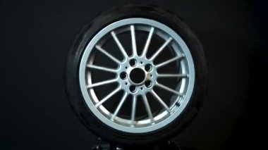 old car wheels titanium rims long exposure video on dark background spinning motion simulation