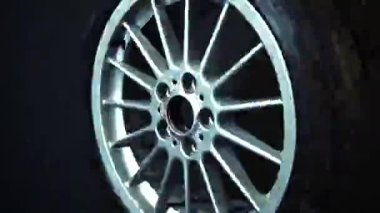 old car wheels titanium rims long exposure video on dark background spinning motion simulation