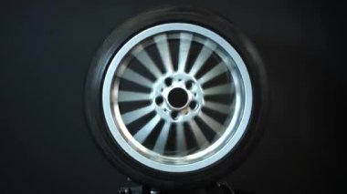 old car wheels titanium rims long exposure video on dark background spinning motion simulation