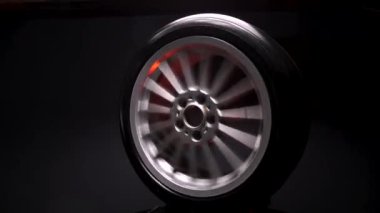 old car wheels titanium rims long exposure video on dark background spinning motion simulation