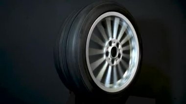 old car wheels titanium rims long exposure video on dark background spinning motion simulation