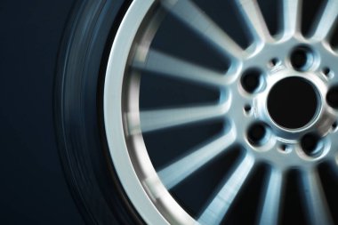 old car wheels titanium rims long exposure video on dark background spinning motion simulation