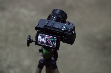 the process of filming a turbo car green on a black camera a mechanic disassembles an old dirty car engine on a red lift for repair
