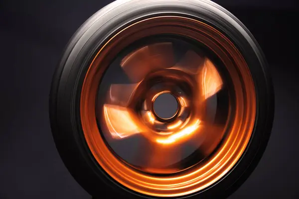 orange metal welded rims car wheels for a drift car custom tuning long exposure photo motion blur effect