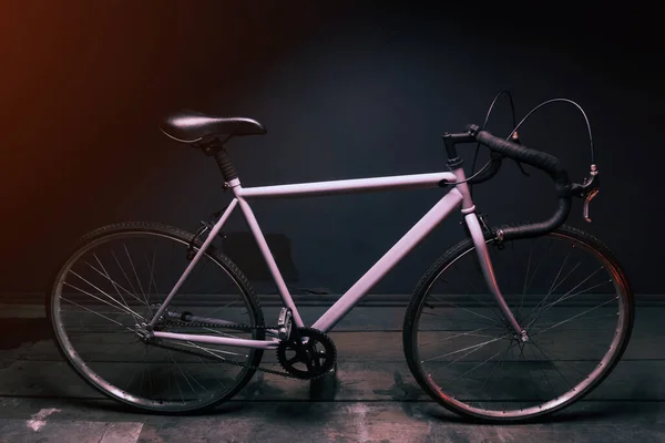 Gri Sokak Bisikleti Kırmızı Işıkla Aydınlatılmış Karanlık Bir Odada — Stok fotoğraf