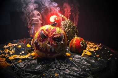 Kırmızı ışıkta balkabaklarıyla ve eski gaz lambalarıyla korkunç bir cadılar bayramı ve karanlık ve korkunç bir yerde kutlama hazırlığı.