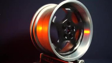 old car wheels titanium rims long exposure video on dark background spinning motion simulation