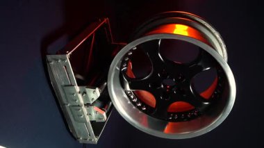 old car wheels titanium rims long exposure video on dark background spinning motion simulation