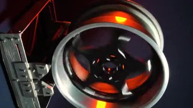 old car wheels titanium rims long exposure video on dark background spinning motion simulation