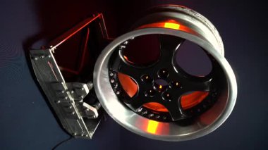 old car wheels titanium rims long exposure video on dark background spinning motion simulation