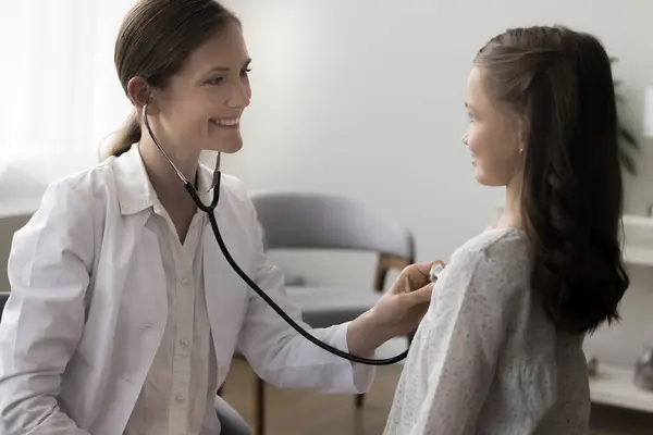 Lächelnd Lächelnde Attraktive Kinderärztin Mantel Hört Kleinen Mädchen Mit Stethoskop — Stockfoto