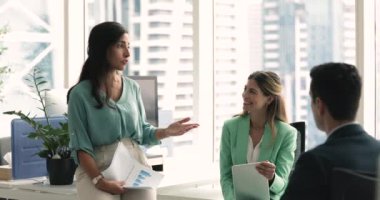 Şirin Latin iş kadını, iş eğitmeni, bayan patron yeni görevler hakkında açıklama yapar, şirket çalışanlarına şirket projesinden veya hedeflerinden bahseder, plan yapar, tartışır, brifinge katılır