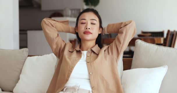 Serene Asian Woman Sit Sofa Hands Head Spend Time Cozy — Stock Video