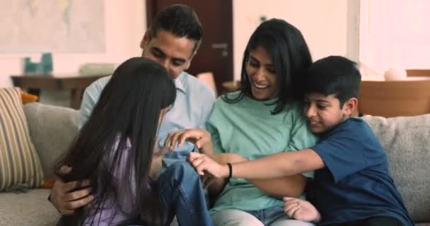 Beautiful Indian Family Little Children Sit Sofa Play Together Tickling — Stock Video