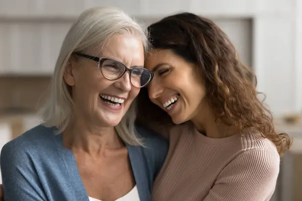 Cheerful Loving Senior Mom Glasses Pretty Adult Daughter Woman Hugging Royaltyfrie stock-billeder
