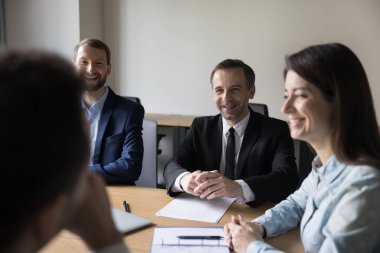 Neşeli takım arkadaşları sabah brifinginde yer alır, güler, fikirleri paylaşır, yaratıcı işbirliğinin, dostça ilişkilerin ve başarılı takım çalışmalarının keyfini çıkarırlar. İş, anlaşma, eğlence.