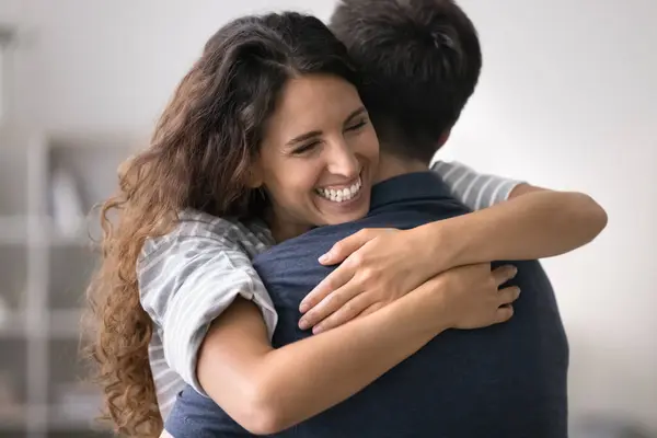 stock image Happy loving pretty wife tenderly hug husband, congratulates him on holiday, celebrate wedding anniversary, express love and devotion, grateful for support, cuddling after long separation, close up