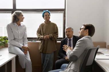 Dört çok ırklı takım arkadaşı birlikte çalışma, gülme, gülümseme ve aynı zamanda yaratıcı çözümler, görüşler, vizyon ve düşünceler alışverişinde bulundular, ortak proje üzerinde çalıştılar, arkadaşça iş ilişkileri kurdular.