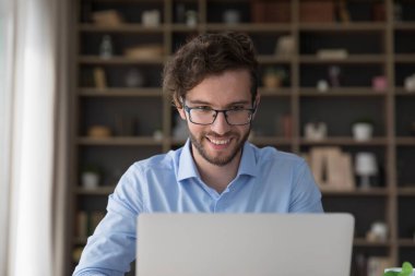 Dizüstü bilgisayarda yazan, gülümseyen, e-posta okuyan, göreve hazırlanan, internette çalışan, mesajları paylaşan, pazar uygulamasını kullanarak hizmet satın alan tatmin olmuş milenyum erkek serbest yazar. SEO uzmanlık alanı iş akışı, iş seyahati