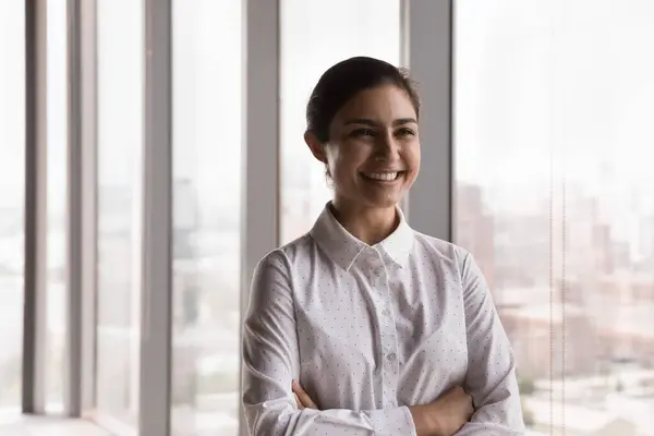 stock image Young attractive Indian businesswoman smile pose in company office. Female intern or student feels happy photoshoot indoor. Ambitious employee, teacher, professional occupation person portrait concept