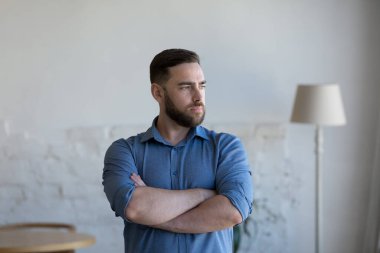 Düşünceli, düşünceli, bin yıllık sakallı bir adam rahat bir ev odasında kollarını göğsüne bağlamış düşüncelerin derinliklerine bakıyor. Hayal kurmak, arama çözümü, düşünce kavramı