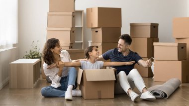 Aile yeni bir daireye taşınıyor. Sevimli ergen kız, karton kutuda oturup gülümseyen anne babasıyla el ele oynaşıyor. Taşınmak için izin alıyor. Kendi evinde eğleniyor.