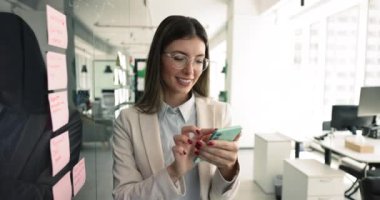 Modern ofis iş kadınlarında, akıllı telefon kullanan kadın çalışanlar, iş arkadaşı veya şirket müşterisiyle bilgi alışverişinde bulunanlar, uzaktan yardım sağlayanlar, iş arkadaşıyla sohbet edenler, e-posta yazanlar