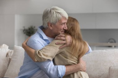 Mutlu, sevgi dolu, yaşlı bir baba yetişkin bir kıza sarılıyor, gülümsüyor, teselli veriyor, destek oluyor, sempati duyuyor. Babalar Günü 'nü kutlayan kadın, tanışmaktan zevk alan kadın, sıcak bir ilişki.