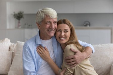 Mutlu yaşlı baba, neşeli yetişkin güzel kıza sevgiyle sarılıyor, gülüyor, güzel düşüncelerle yüzünü çeviriyor, gülümsüyor, konuşuyor, düşünüyor, eğleniyor, ilişki kuruyor, bağ kuruyor, babalık yapıyor.