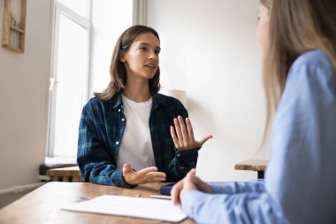 Kadın, ofiste toplanan müvekkil veya meslektaşlarına yararlı bilgiler sunar, masa başı sohbetinde oturur, ortak projeyi tartışır. Başvuru sahibi iş görüşmesini geçti. Sorulara cevap güvenli görünüyor.