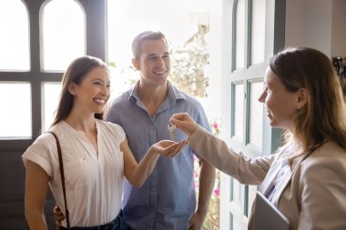 Pozitif ev sahibi, emlakçı, emlakçı kadın yeni evden mutlu ev sahiplerine, kiracılara, ev sahiplerine anahtarı veriyor. Kiracılar emlakçıyla toplantı yapıyor.