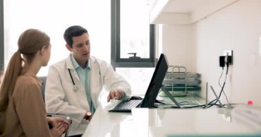 Yakışıklı Latin doktor kadın hastaya elektronik sonuçlara bakmasını söylüyor. İş yerindeki bilgisayar monitörüne işaret ediyor. Konuşuyor, teşhis koyuyor, tıbbi rapor yazıyor.