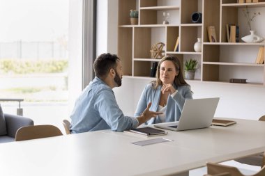 Modern konferans odasında iki iş ortağıyla görüşmeler. Hispanik ve Avrupalı takım arkadaşları ortak projeyi tartışıyor, ofis takım çalışması, iş dünyası, iletişim konularını çözüyorlar