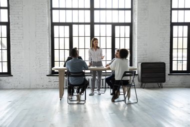 İş adamları masa başında oturup beyin fırtınası yapar modern çatı katındaki grup toplantılarında fikirleri tartışır, iş arkadaşlarıyla brifing verir, birlikte iş birliği yapar, takım çalışması kavramı oluştururlar.