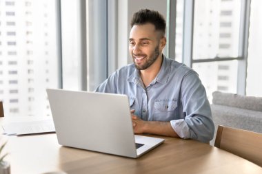 Tele-iş için dizüstü bilgisayar kullanan, kişisel ya da iş konularında video görüşmesi yapan, pazardan mal alan, eğitim platformu üzerinden eğitim gören bir adam. Yapay zeka, modern teknoloji, hobi