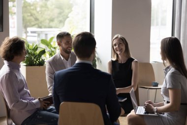Çeşitli milenyum iş adamları modern ofis içinde toplanıyor, daireler çiziyor, gülümsüyor, olumlu sohbetlerin tadını çıkarıyor eğitimde veya sabah brifinginde yer alıyorlar. Takım çalışması süreci, proje tartışması